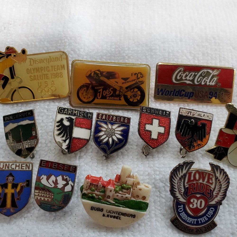 vintage pins of International coat of arms, Disney, Harley Davidson